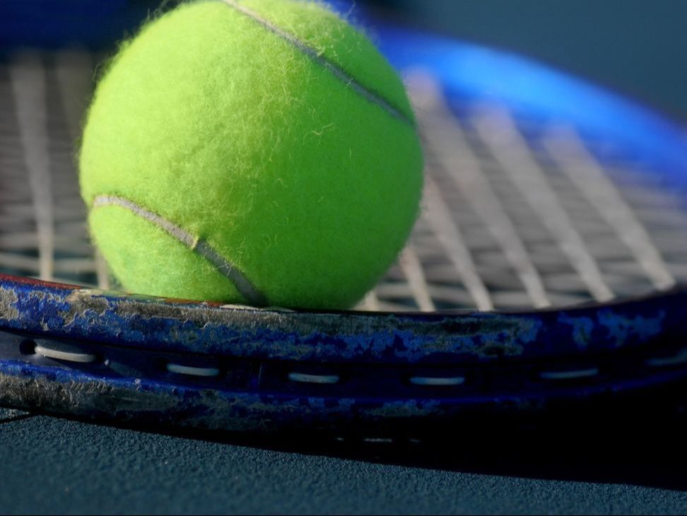 Tennis ball on tennis racket